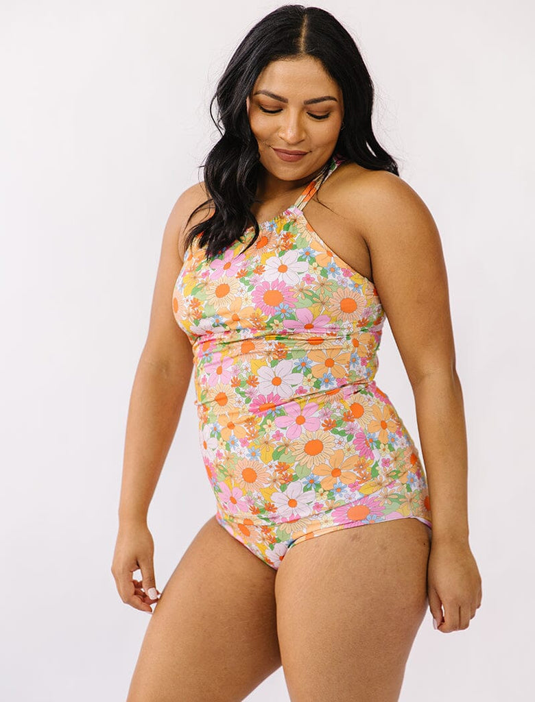 Photo of woman wearing multi colored double strap swim tankini with multi colored floral bottoms