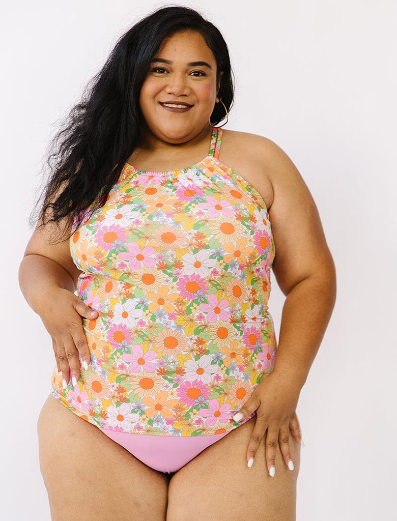 Photo of woman wearing a multi colored double strap swim tankini with pink swim bottoms