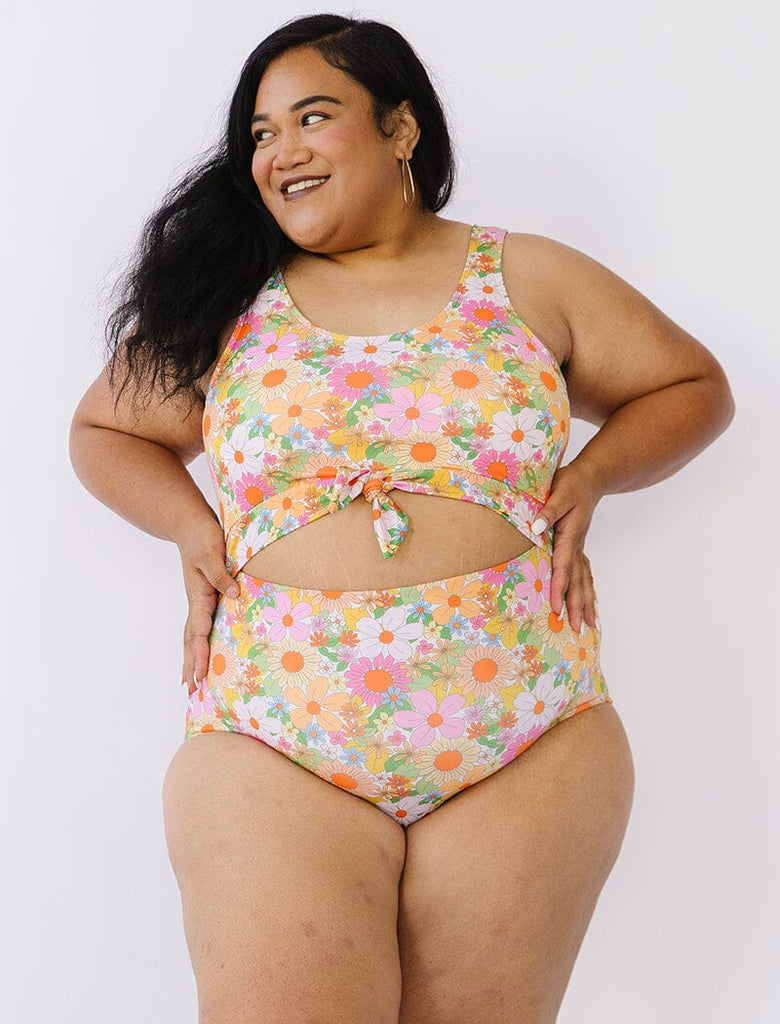Photo of woman wearing multi colored floral knotted swim one piece
