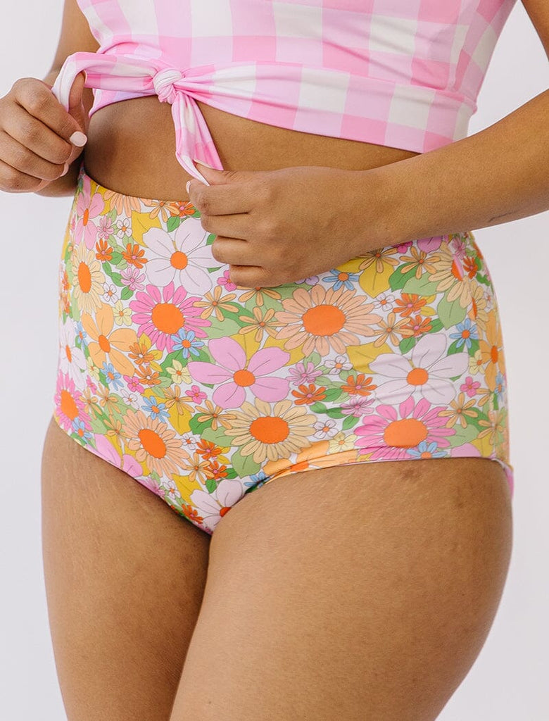 Photo of woman wearing multi colored floral reversible side swim bottoms