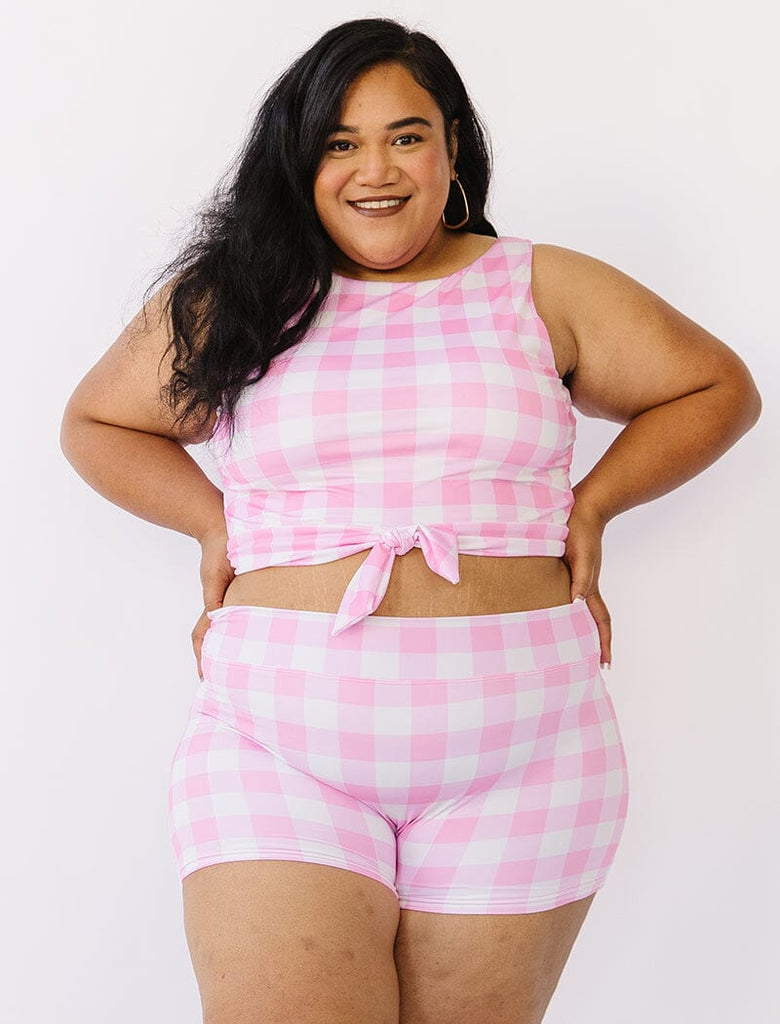 Photo of woman wearing pink gingham cropped swim top with pink gingham swim shorts