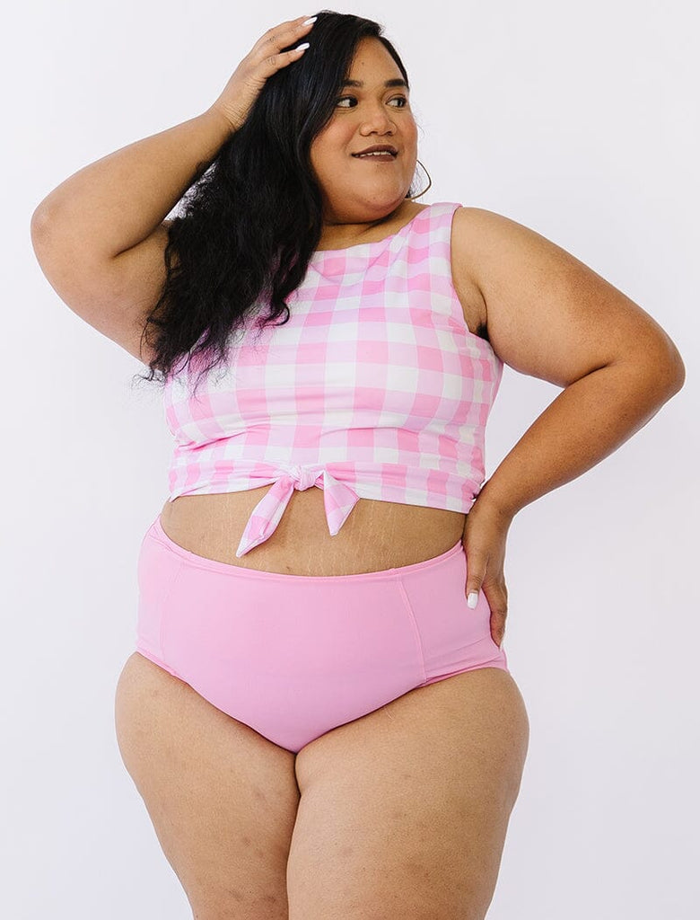 Photo of woman wearing pink gingham cropped swim top with pink swim bottoms