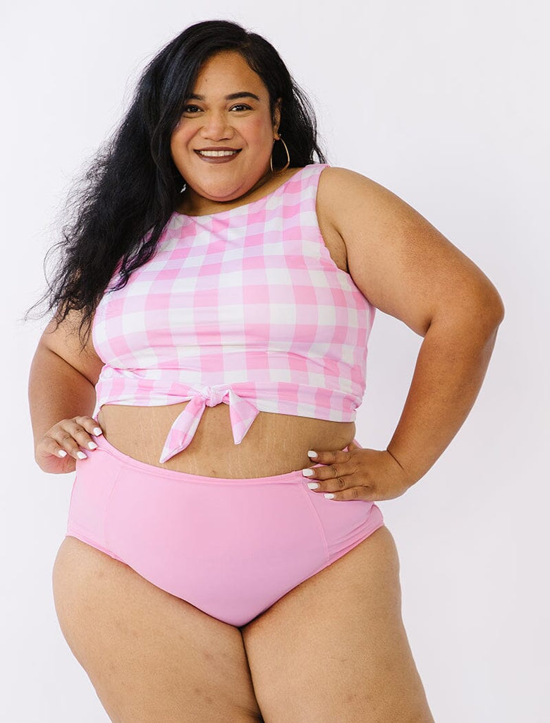 Photo of woman wearing pink gingham cropped swim top with pink swim bottoms