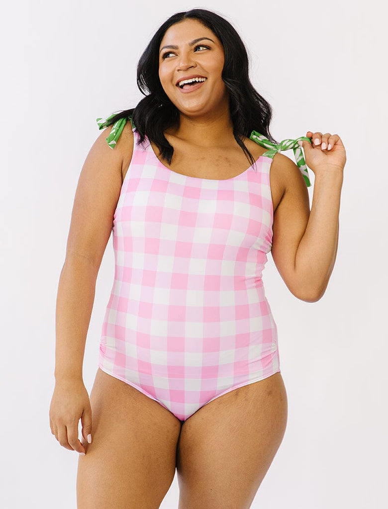 Photo of woman wearing pink gingham swim one piece