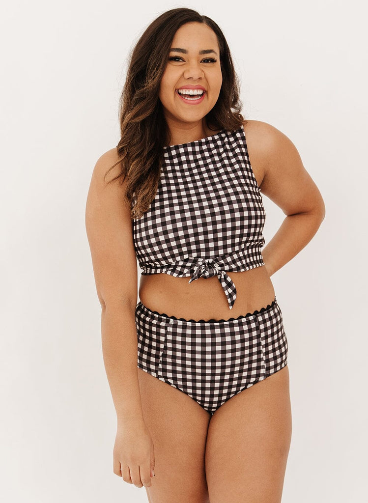 Photo of a woman wearing a black gingham knotted swim crop top with black gingham high-waist swim bottoms