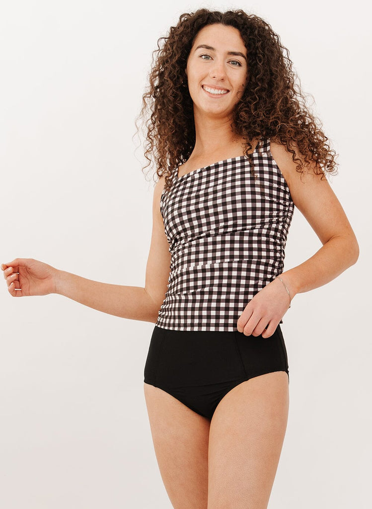 Photo of a woman wearing a black gingham square neck tankini swim top with black swim bottoms