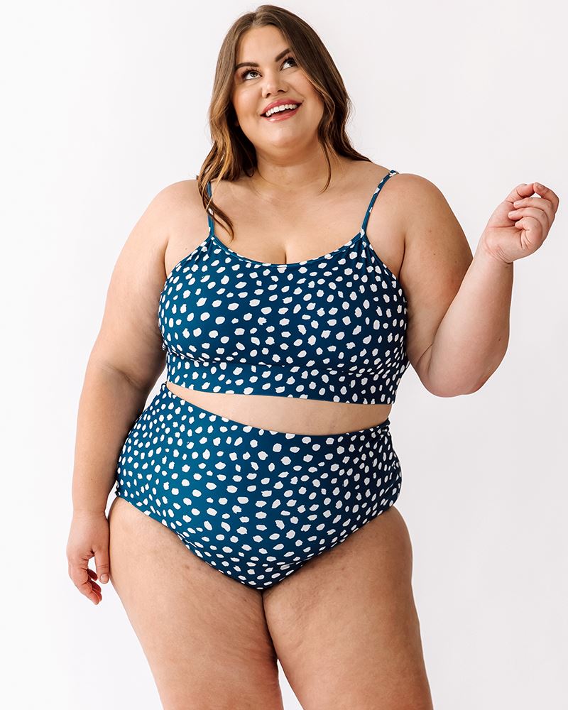 Photo of a woman wearing Indigo dot reversible high-waist bottoms and Indigo dot bralette
