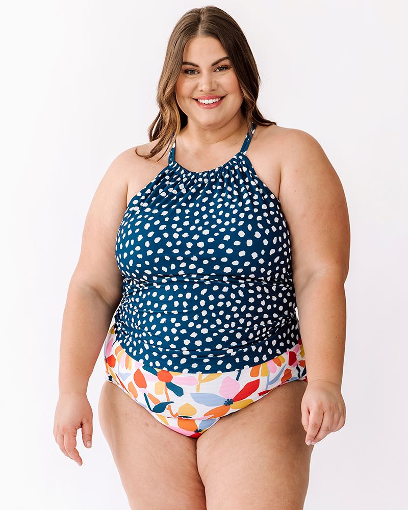 Photo of a woman wearing an Indigo dot double-cinch swim top and a multi color floral swim bottom