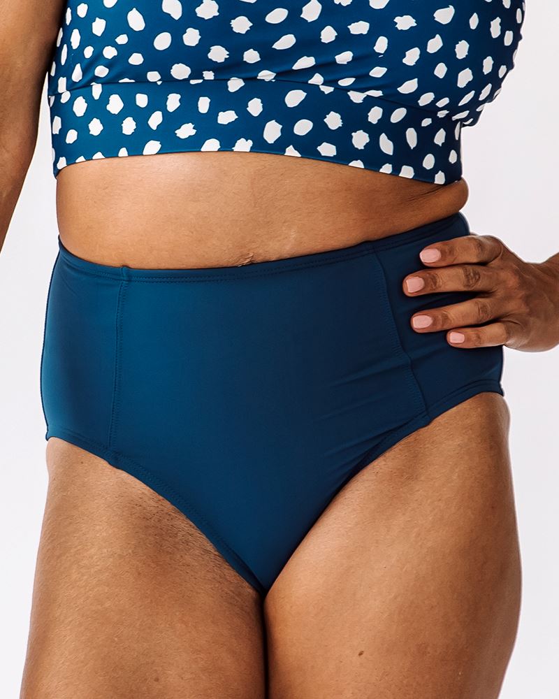 Photo of woman wearing blue high waisted swim bottoms