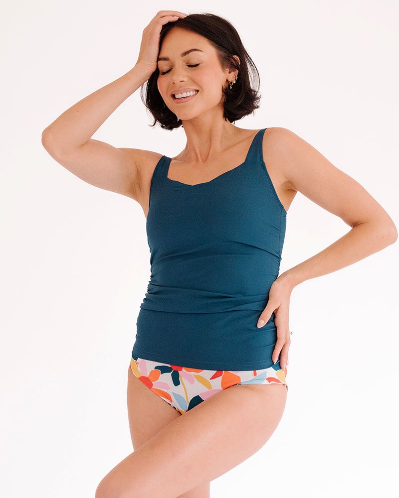 Photo of a woman wearing an Indigo square neck swim top and a multi color floral swim bottom