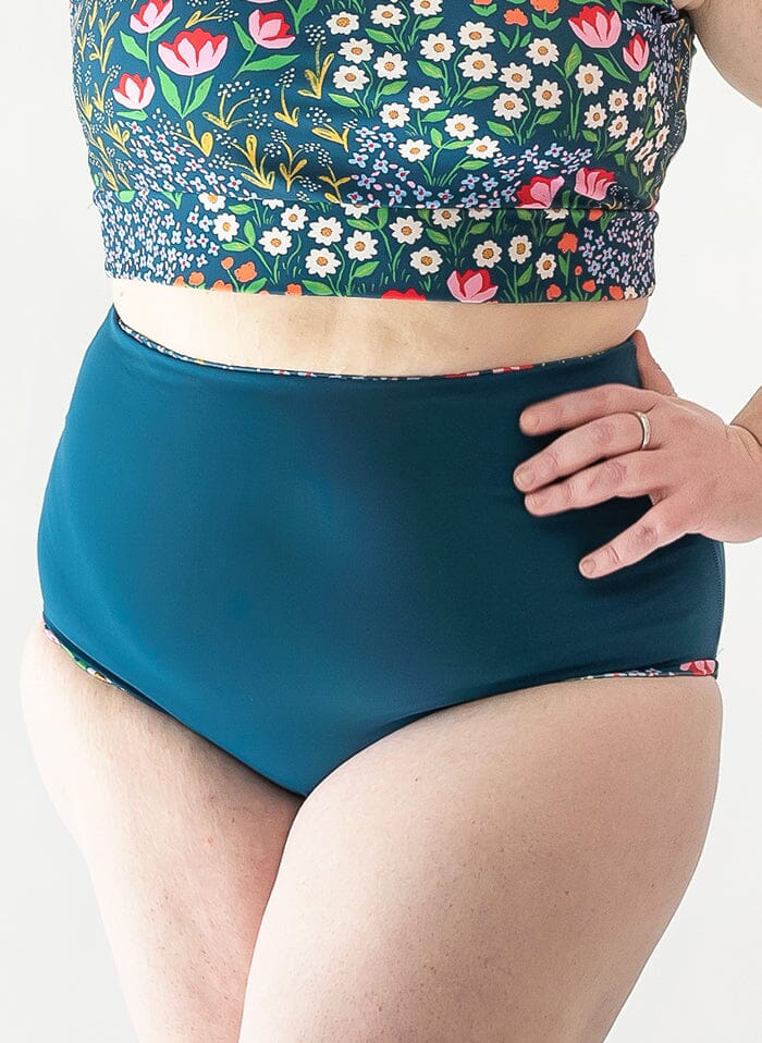 of a woman wearing a Blixen/Indigo reversible swim bottom indigo side