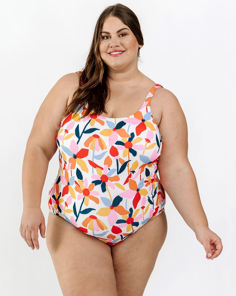 Photo of a woman wearing a June floral one-piece swim suit