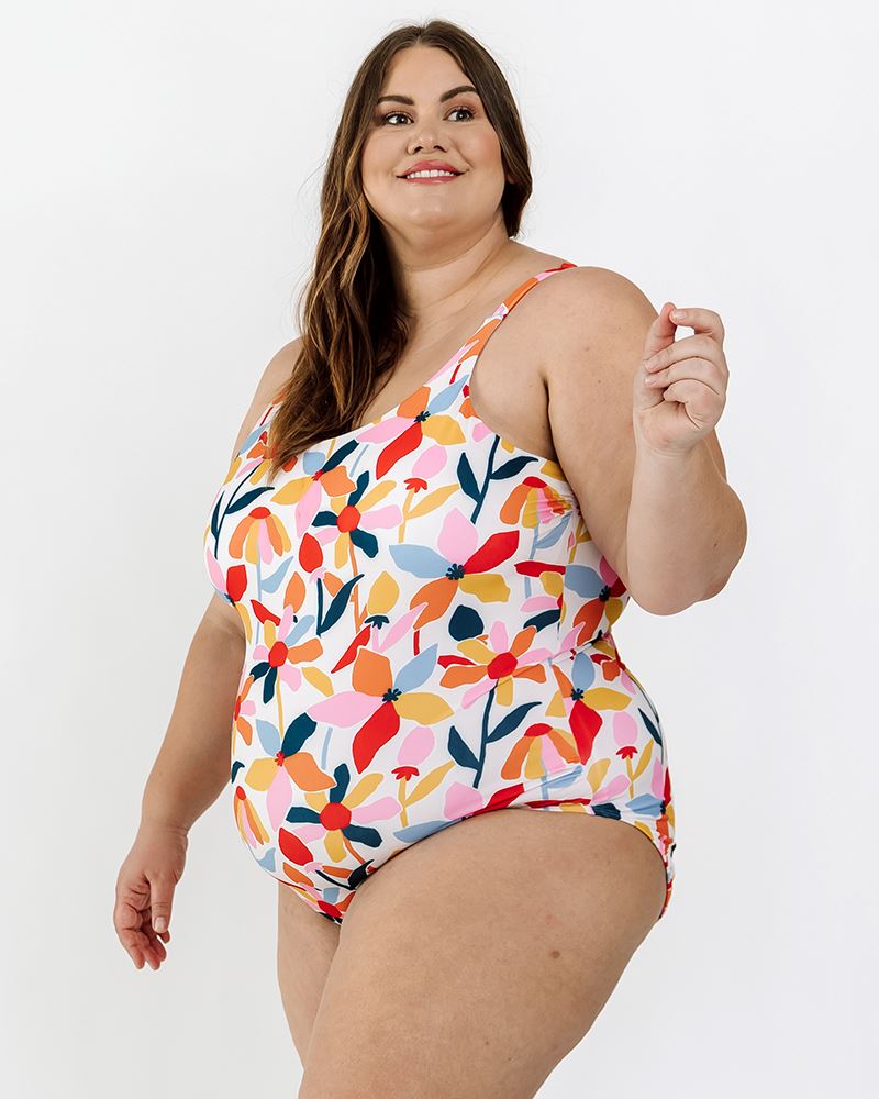 Photo of a woman wearing a June floral one-piece swim suit side angle