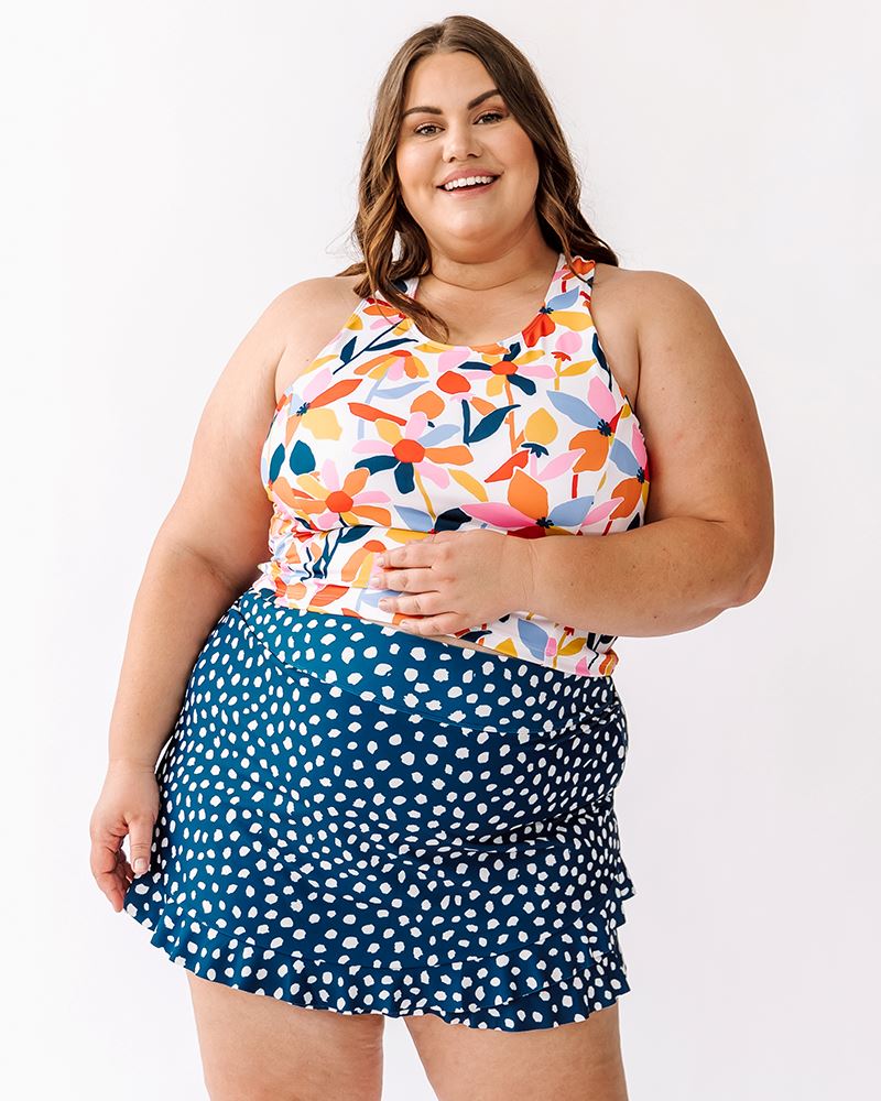 Photo of a woman wearing Indigo Dot swim skirt and June Floral racer back