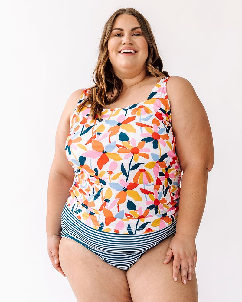 Photo of a woman wearing a June floral square neck swim top and an Indigo stripe swim bottom