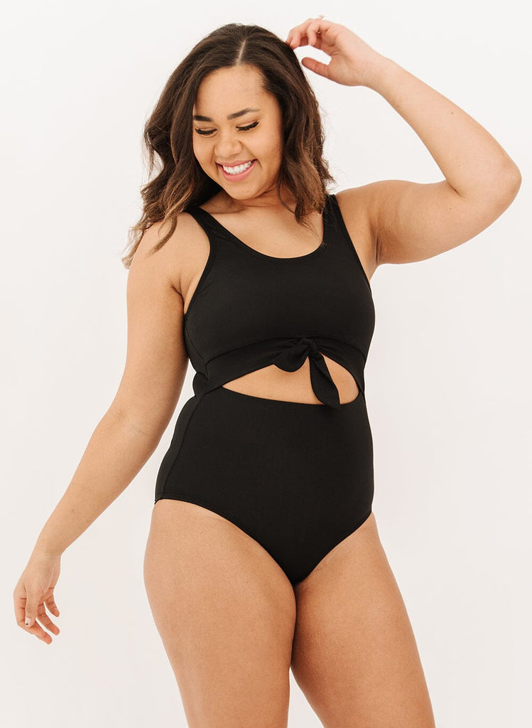 Photo of a woman wearing a black knotted one-piece swim suit