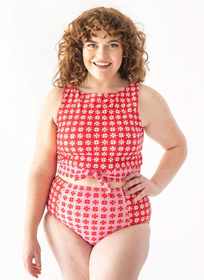Photo of a woman wearing a pink Margrethe swim bottom and a Red Margrethe swim crop top