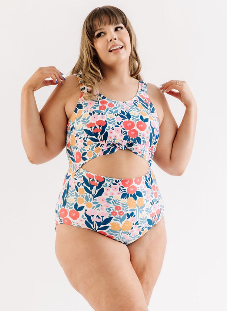 Photo of a woman wearing a May Flowers knotted one-piece swim suit