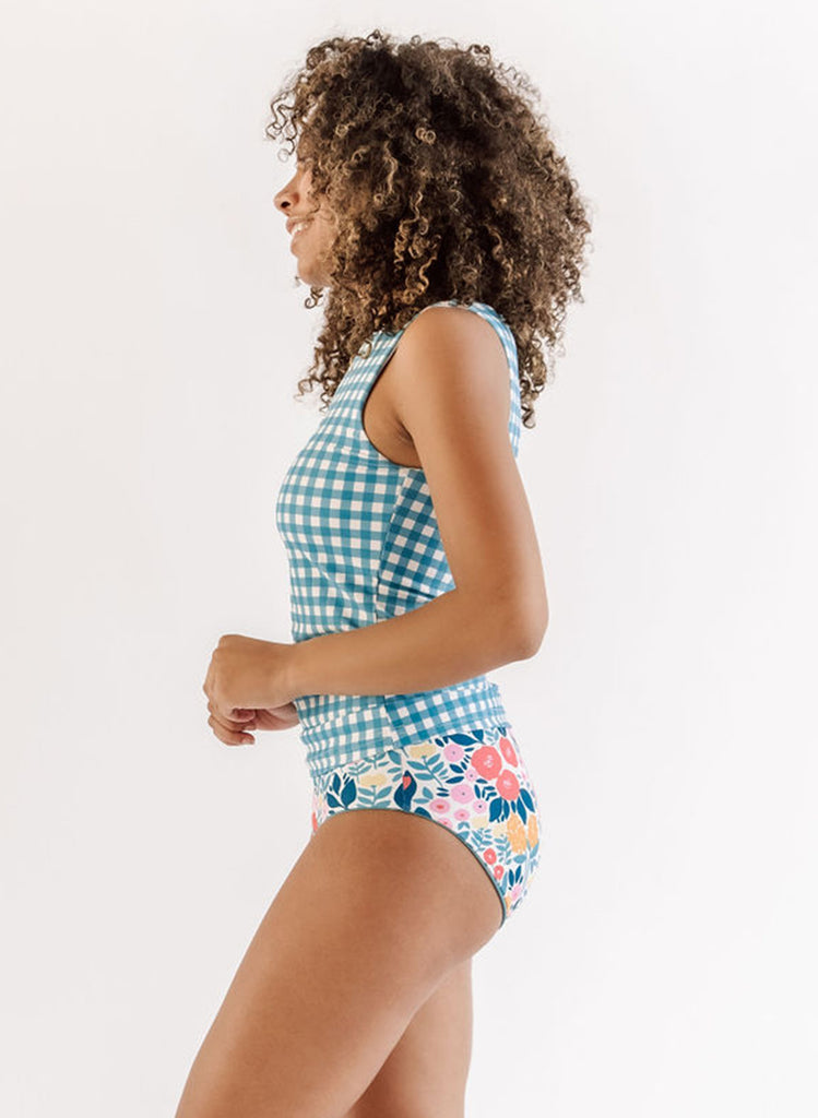 Photo of a woman wearing an Ocean classic swim bottom and a may flowers swim bottom side angle