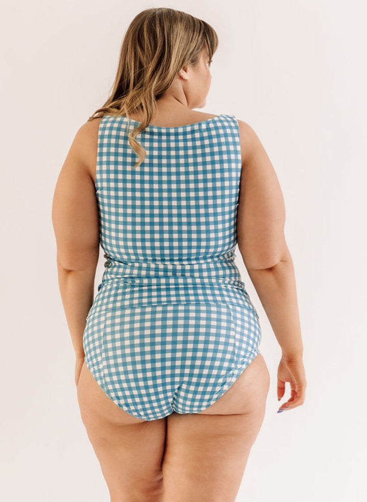 Photo of a woman wearing an Ocean classic swim bottom and an ocean gingham swim bottom back angle