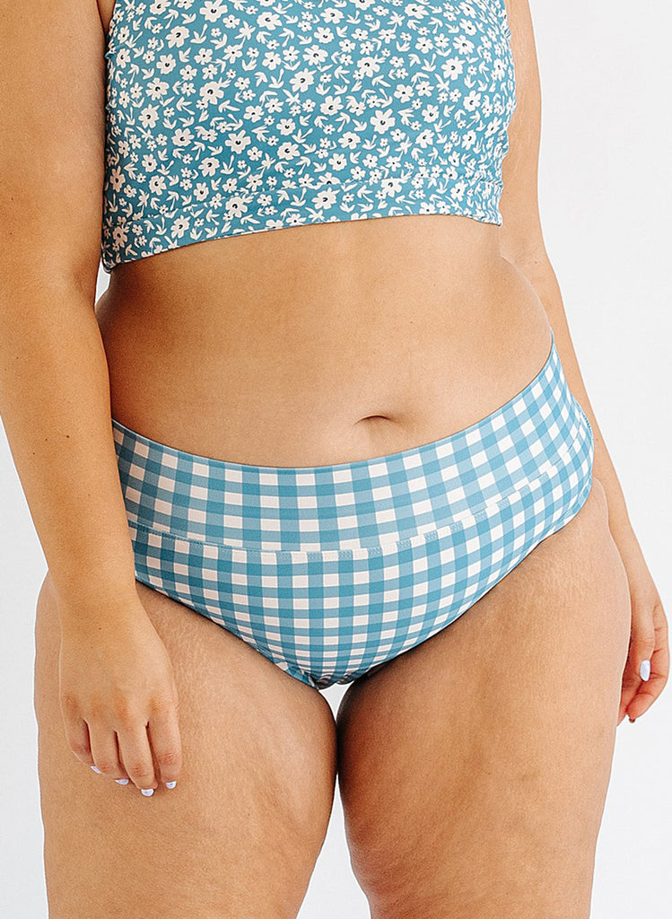Photo of woman wearing blue and white gingham swim bottoms