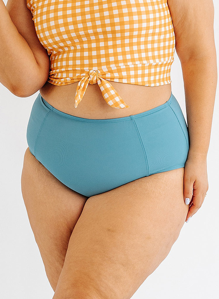 Photo of woman wearing blue high waist swim bottoms