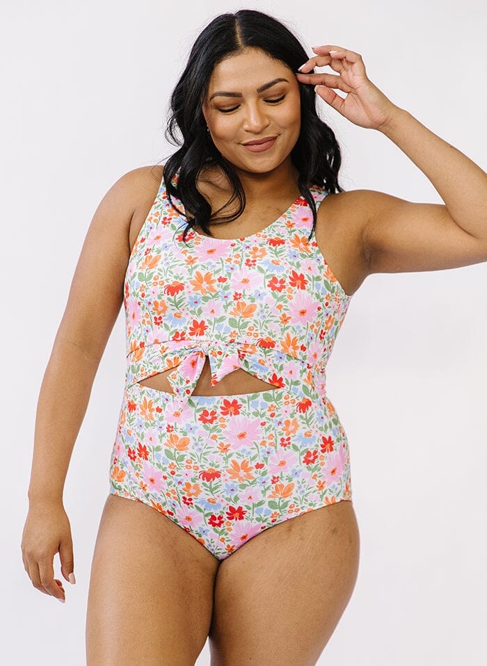 Photo of a woman wearing a floral knotted swim one piece