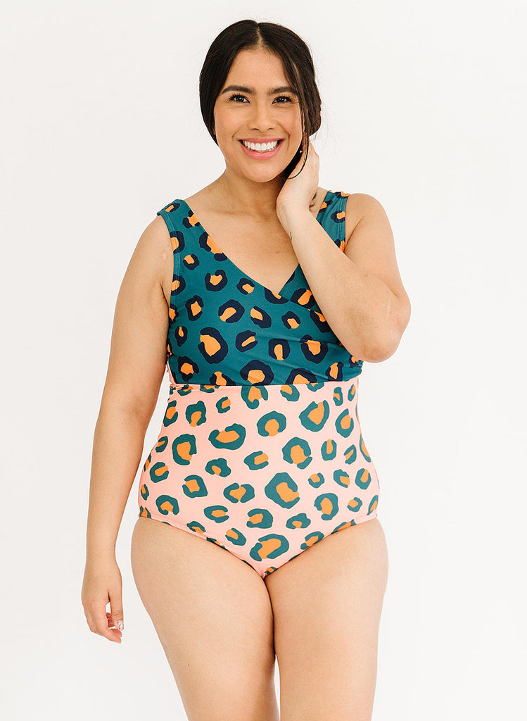 Photo of woman wearing blue and pink leopard print one piece swimsuit