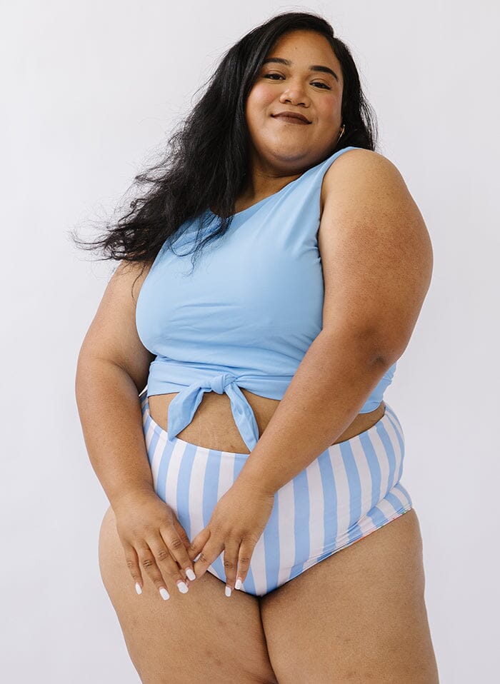 Photo of a woman wearing a peri swim crop top and a peri stripe swim bottom