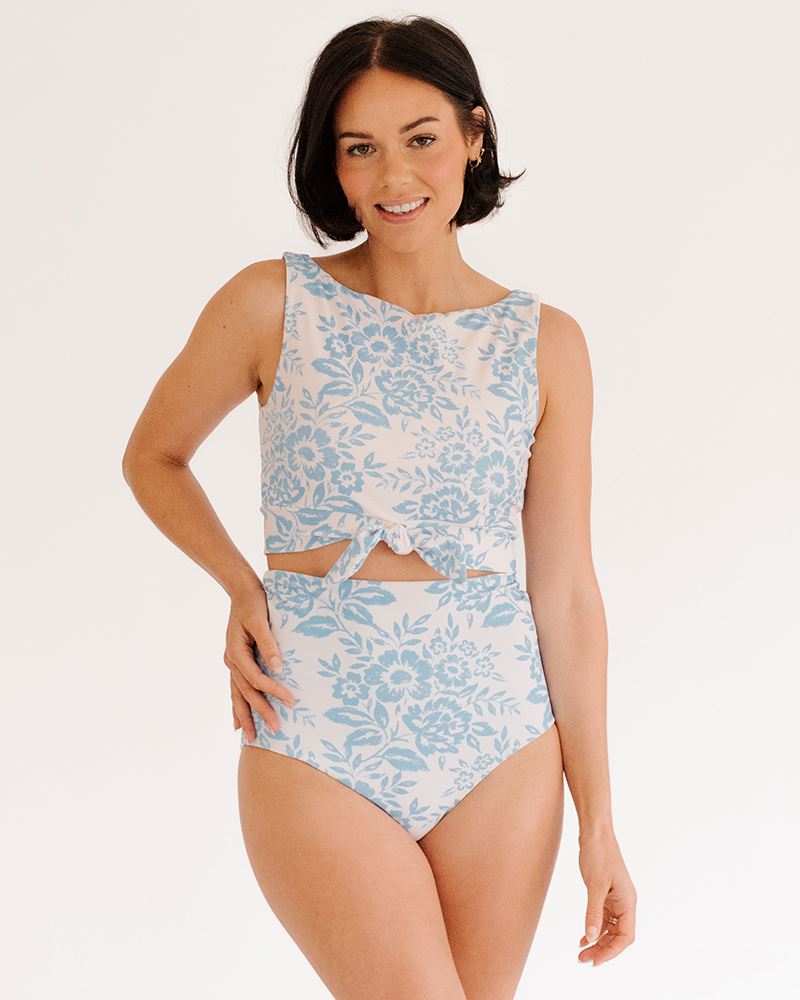 Photo of a woman wearing a Peri Lace/ Peri reversible swim bottom Lace side and a Peri Lace swim crop top