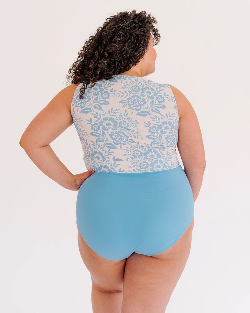Photo of a woman wearing a Peri Lace knotted swim crop top and a Peri swim bottom back angle