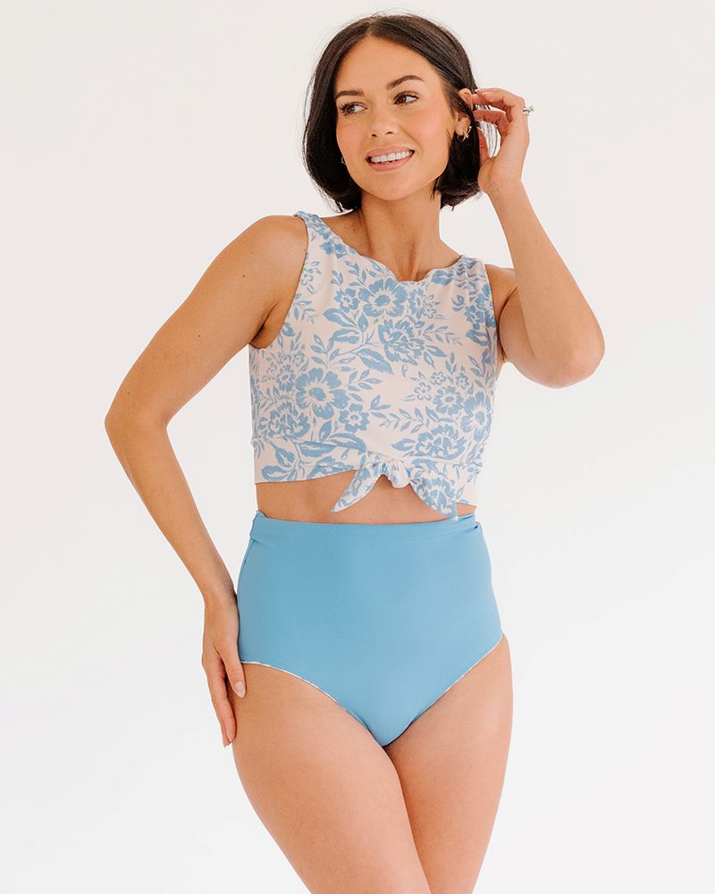 Photo of a woman wearing a Peri Lace knotted swim crop top and a peri swim bottom