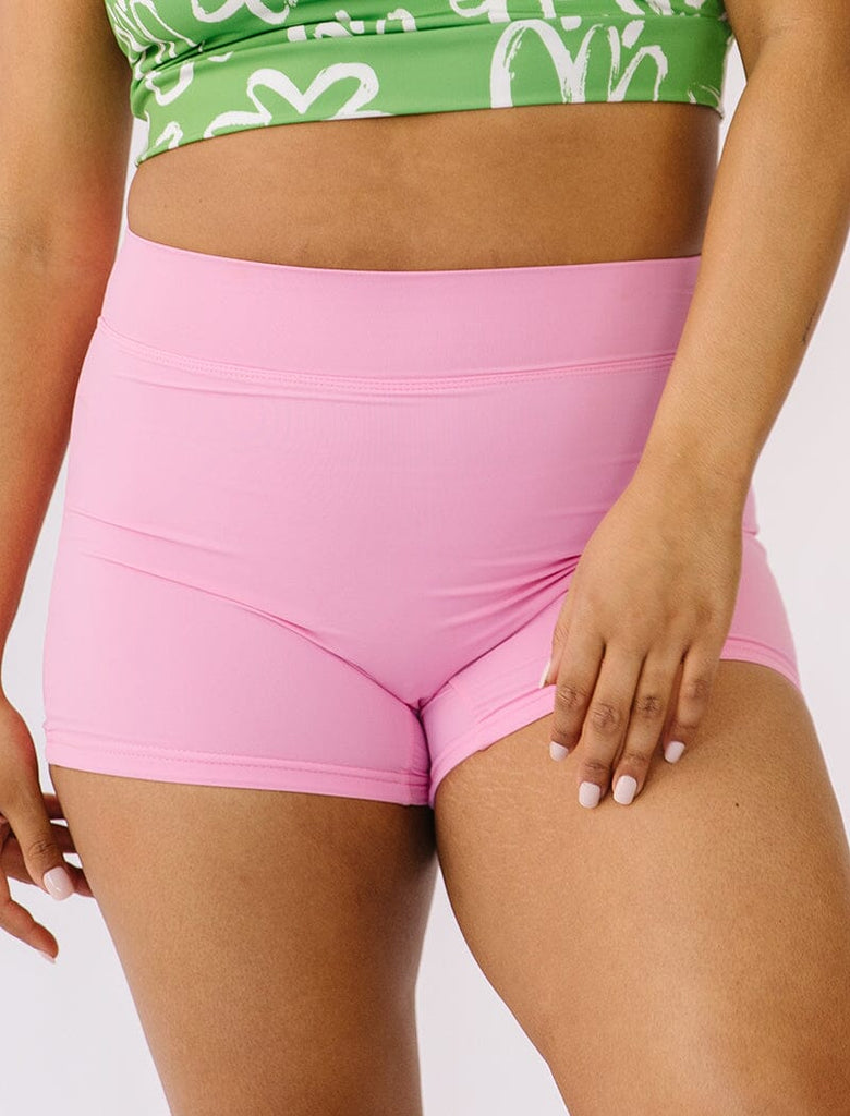 Photo of woman wearing pink swim shorts