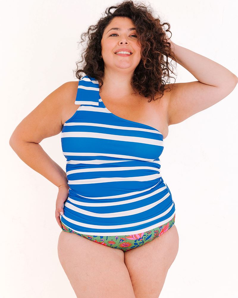 of a woman wearing a Capri one-shoulder swim top and a Fresco floral swim bottom