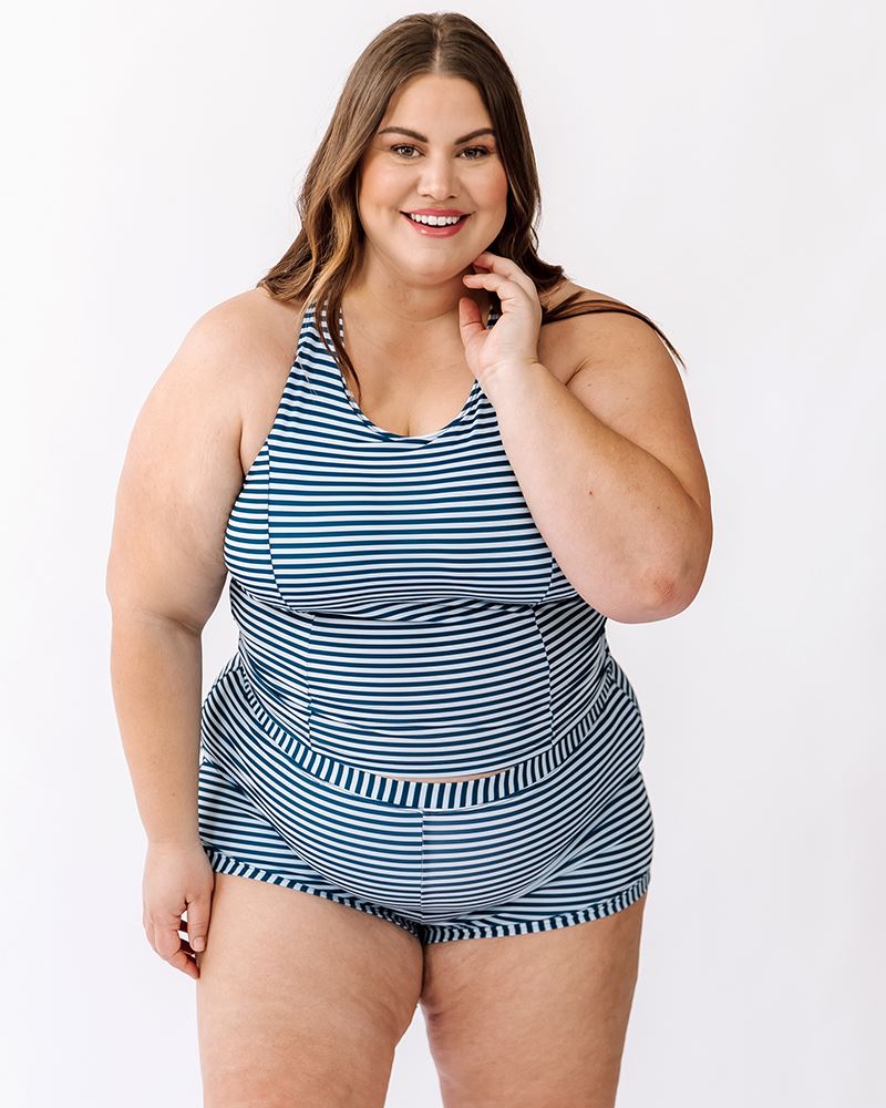 Photo of a woman wearing an Indigo retro swim short bottom and an Indigo stripe swim crop top