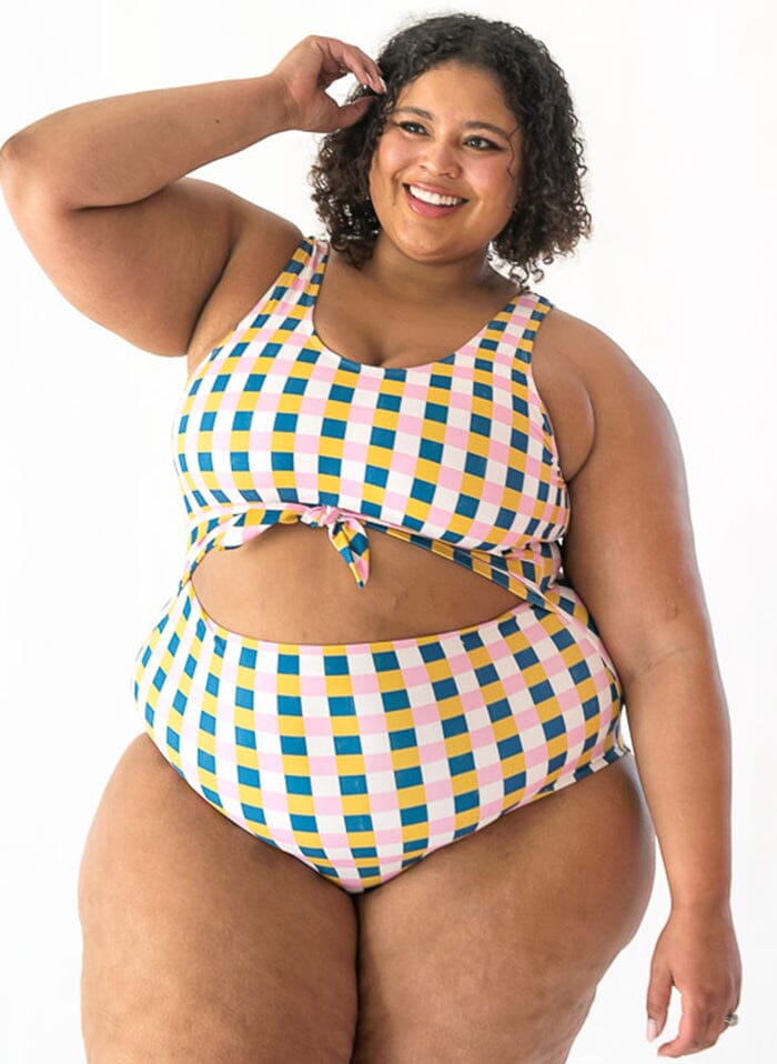 Photo of woman wearing multi colored checkered one piece swim suit
