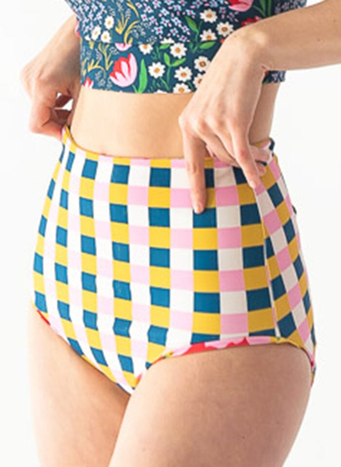 Photo of a woman wearing a Claus/Tage reversible swim bottom checkered side